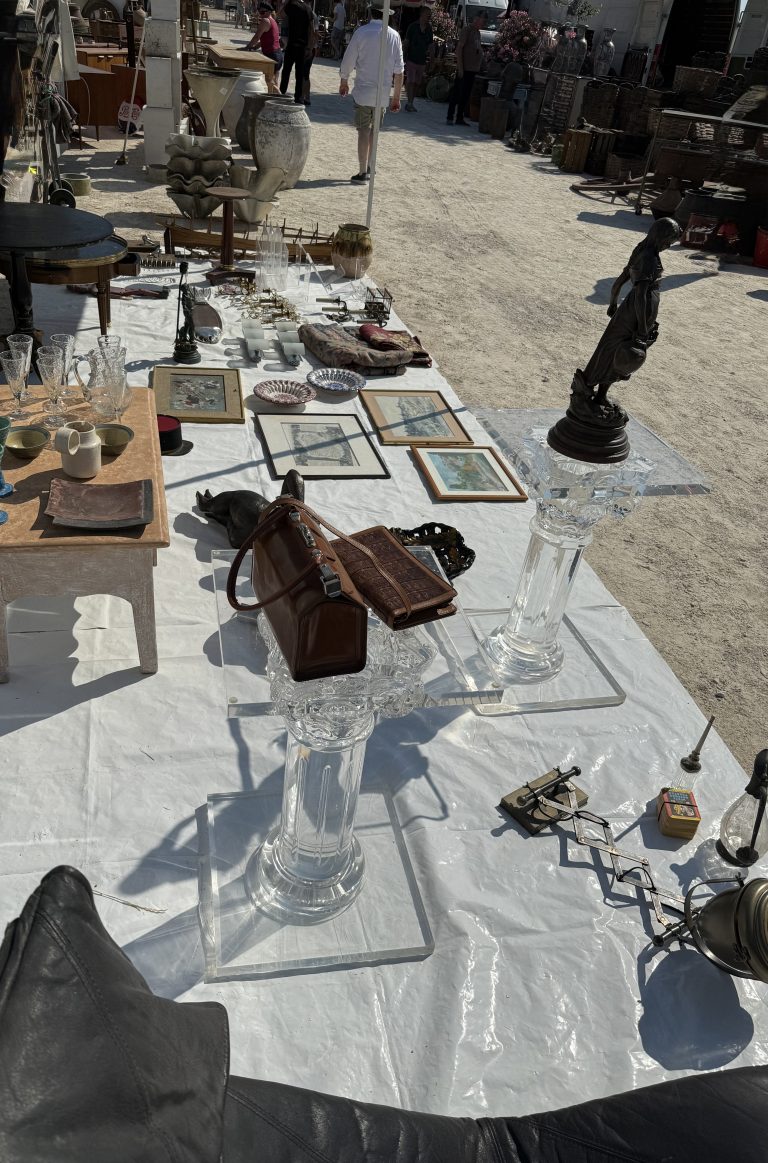 Table de brocante garnie de cristal, gravures encadrées, bronze et petits objets de collection
